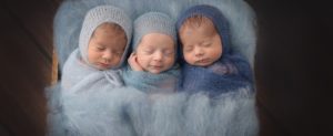 triplets boys blue snuggled smiling