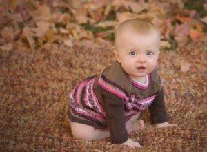 fall baby crawling sweater leaves photos