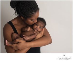 black newborn baby mom kiss one month