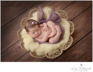 newborn baby girl in purple